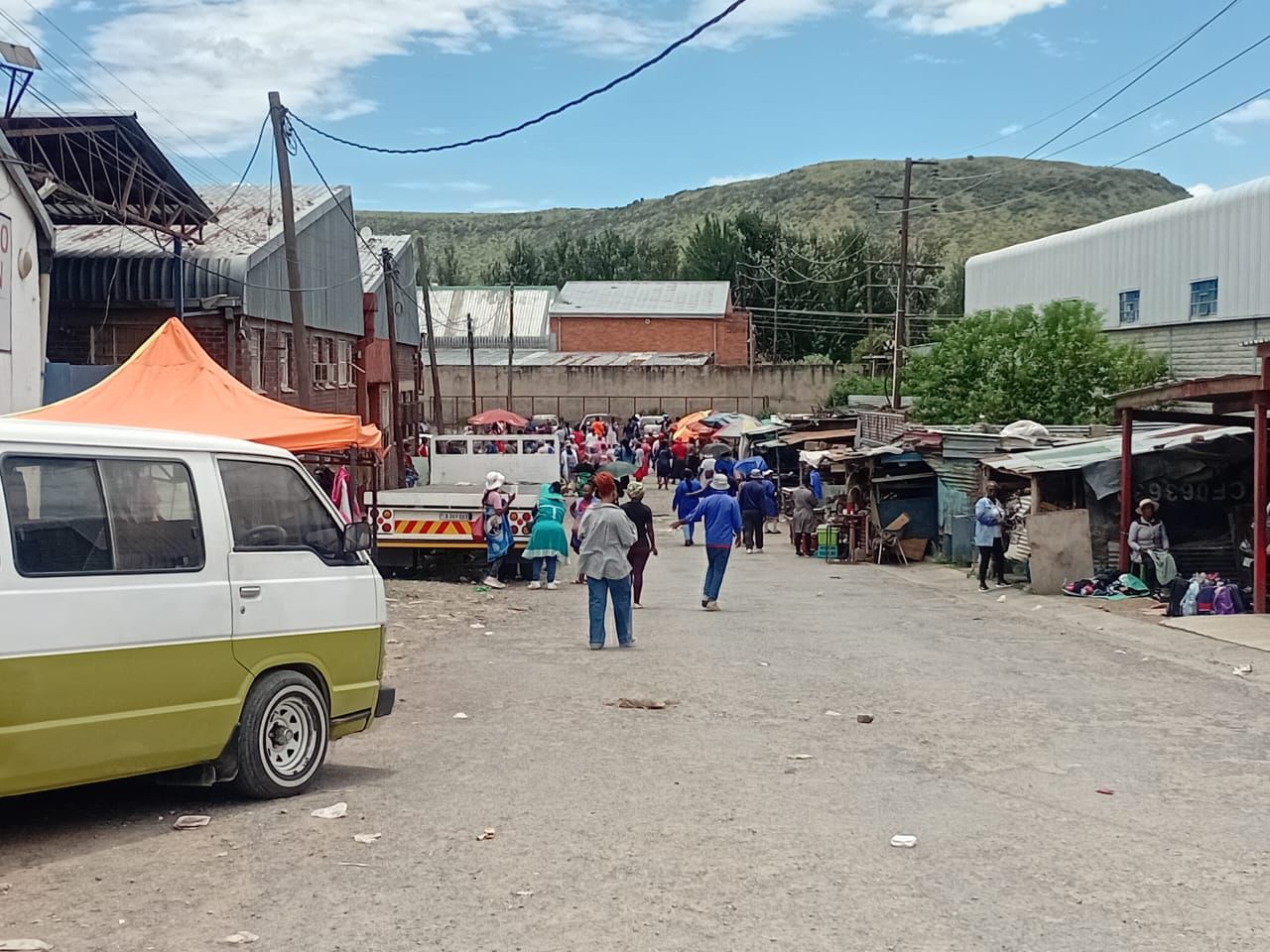 FACTORY WORKERS SETTLE IN BACK INTO ROUTINE